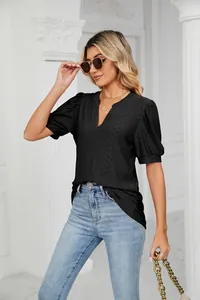 Fashionable women's black V-neck puff sleeve top featuring a delicate hollow-out texture
