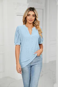 Detail view of light blue V-neck eyelet top with elegant puff sleeves for summer