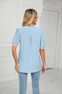 Back view of light blue hollow-out T-shirt with puff sleeves and eyelet texture