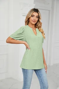 Detail view of a sage green V-neck eyelet puff sleeve loose T-shirt for women.