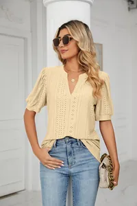 Detail showing textured eyelet pattern of beige puff sleeve V-neck summer blouse