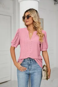Detailed view of pink V-neck summer blouse with eyelet lace and stylish puff sleeves
