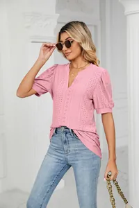 Close-up of pink puff sleeve t-shirt with hollow eyelet pattern and V-neckline