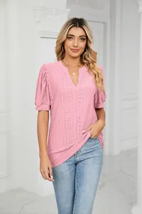 Close-up of pink eyelet blouse featuring bubble sleeves and elegant v-neck design