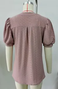Back view detail of mauve eyelet puff sleeve blouse on a professional mannequin stand
