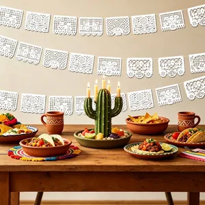 Elegant white Mexican Papel Picado banners decorated with floral and bird cutout patterns