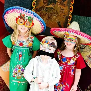 Kids wearing Mexican festival paper glasses with pinata and cactus designs