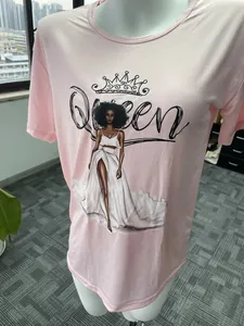 Detailed view of pink crew neck t-shirt featuring 'Queen' graphic and crown print