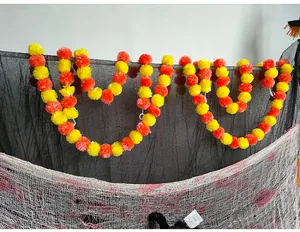 Detailed view of vibrant orange and yellow marigold garlands for festive decorations