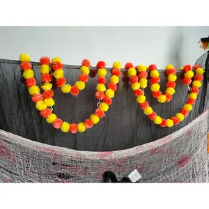 Detailed view of yellow and orange marigold garlands on Halloween decorative nets.