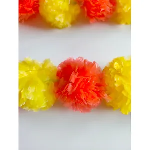 Close-up of vibrant yellow and orange artificial marigold flower garlands for decor
