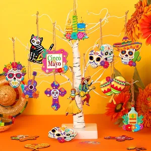 Detailed Mexican Day of the Dead wooden hanging ornaments on a decorative white tree