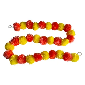 Detail of orange and yellow artificial marigold garland for Indian wedding decoration.