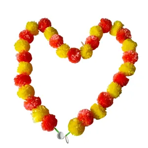 Heart-shaped marigold garland decoration with orange and yellow plastic pom-pom flowers