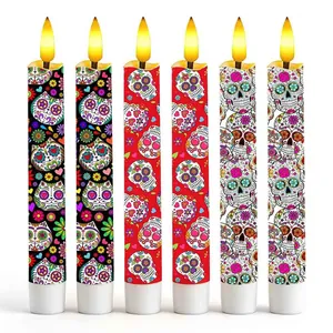 Close-up of six LED candles featuring vibrant Mexican Day of the Dead sugar skull patterns