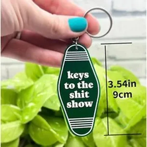 Detailed view of the green wooden key tag showing 9cm dimensions and funny text
