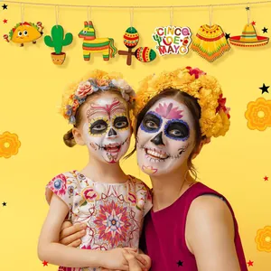 Mexican festival wooden ornaments hanging over models in festive face paint