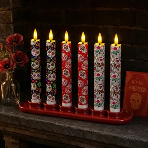 Detailed view of Day of the Dead LED candles with sugar skull patterns on a mantel
