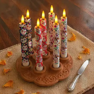 Detailed close-up of colorful Day of the Dead LED candles featuring sugar skull designs.