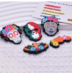 Detailed view of colorful Day of the Dead PVC shoe charms with skull and floral designs