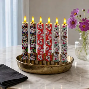 Detailed view of Day of the Dead LED candles with colorful sugar skull patterns