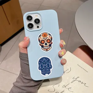 Detailed macro view of waterproof Day of the Dead sugar skull stickers on a phone case