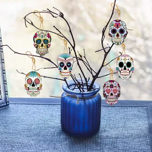 Detailed view of colorful Day of the Dead sugar skull pendants hanging on branches.