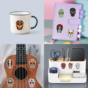 Day of the Dead sugar skull stickers decorating a mug, planner, ukulele, and desk organizer