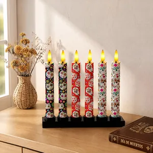 Detailed view of Day of the Dead LED candles with colorful sugar skull patterns