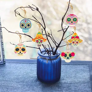 Vibrant Day of the Dead sugar skull paper ornaments hanging on rustic dry branches in a vase