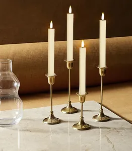 Elegant golden taper candle holders with flickering warm white LED candles for home decor