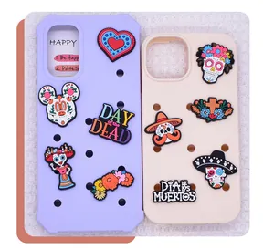 Close-up of Mexican Day of the Dead themed DIY PVC soft rubber charms for phone cases.