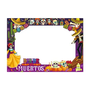 Colorful Dia de los Muertos photo booth frame with sugar skulls and skeletons party decoration