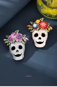 Detailed view of Halloween skull brooches with colorful enamel flower crowns