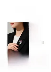 Detailed view of skull brooch with purple enamel flowers and sparkling crystals.