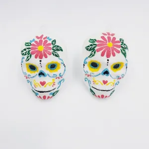 Detail of Day of the Dead sugar skull decorations with colorful painted flower patterns