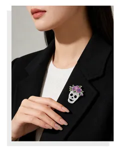 Detailed view of skull brooch with pink flowers pinned on a black blazer lapel