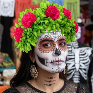 Detail view of a vibrant pink marigold floral headband for Day of the Dead festivities.