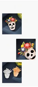 Detail of Halloween skull brooch featuring colorful floral crown and textured finish.