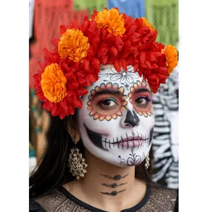 Close-up of Day of the Dead headband with vibrant red and orange marigolds