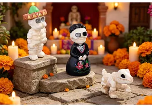 Close-up of Halloween skull figurines and skeleton dog in a festive Day of the Dead scene.