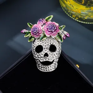 Halloween skull brooch with colorful enamel flowers and silver textured finish