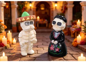 Halloween skeleton couple miniature figurines in a warm festive candle-lit setting