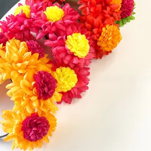 Detailed view of vibrant artificial marigold flowers on Day of the Dead headband.