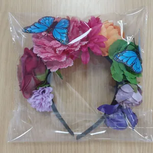 Detailed view of colorful artificial flower headband with butterflies in plastic packaging