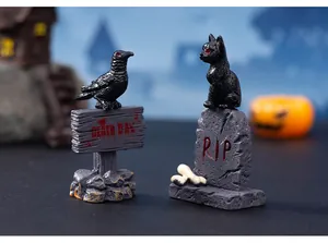 Detailed view of Halloween resin ornaments featuring a black crow and cat on spooky signs.