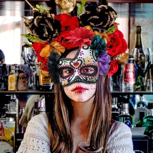 Mexican Day of the Dead masquerade mask with vibrant floral headpiece for Halloween party
