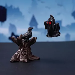 Halloween resin ornaments featuring a black crow on a tree stump and a spooky black ghost