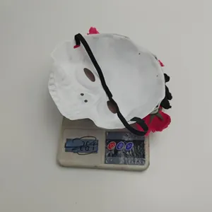 Back view of Mexican floral masquerade mask on an electronic scale showing 26.1g weight