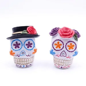 Macro view of colorful Mexican sugar skull resin figurines with flower decorations